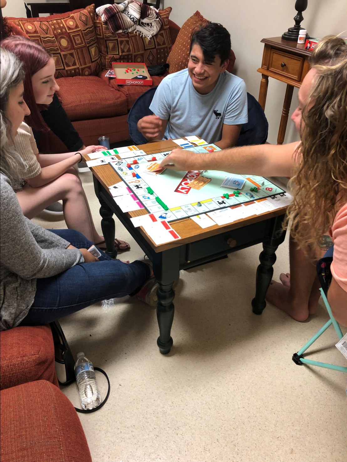 Poala Trujillo (left) Jena Conley (Left red hair) Kobhe Macias (middle) and Sean Ogle enjoy a game of Monopoly.